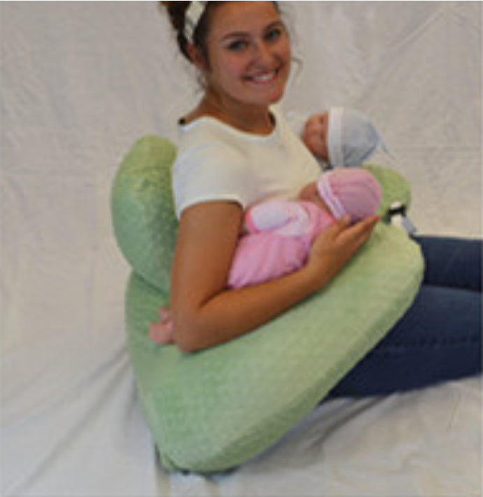 Mother using an Infant Multifunctional Nursing Pillow Cushion while holding two babies.