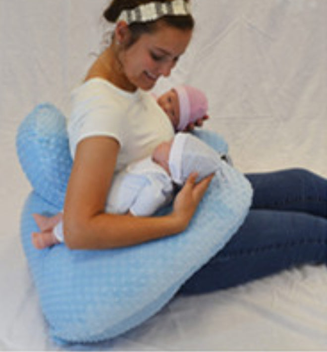 Infant Multifunctional Nursing Pillow Cushion used by a mother holding two babies in a soft blue pillow.